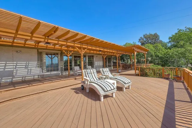 a view of balcony with two chairs and wooden floor