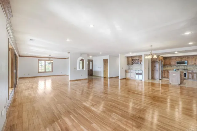 a view of a livingroom with furniture wooden floor and windows