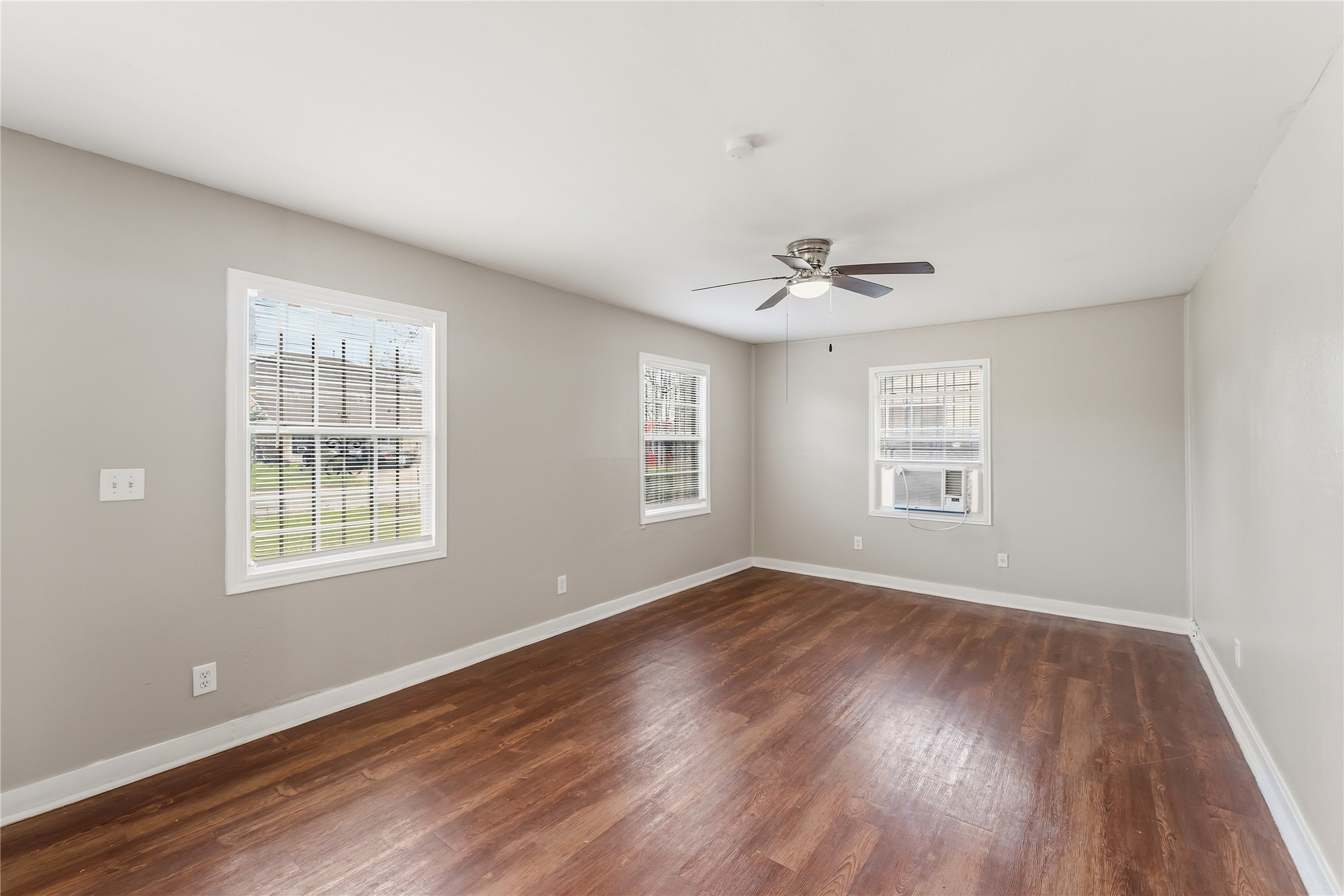 4814 Burma Road Houston, TX 77033 - Photo 2 of 16 Vinyl-wood floors, neutral walls, and ample natural light from multiple windows. It includes a ceiling fan.