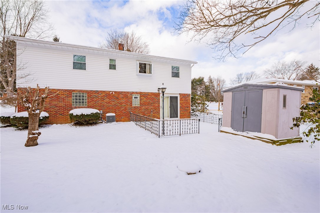 5905 Renninger Road New Franklin, OH 44319 - Photo 26 of 31 Snow covered property with a storage shed