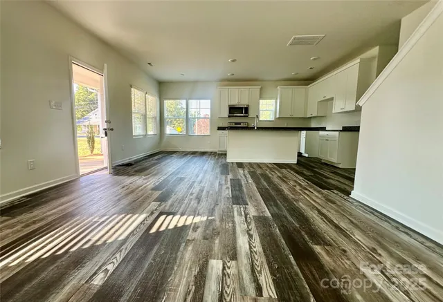 a view of kitchen with sink and wooden floor