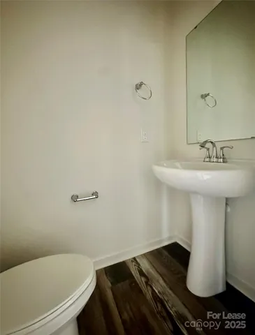 a bathroom with a sink toilet and mirror