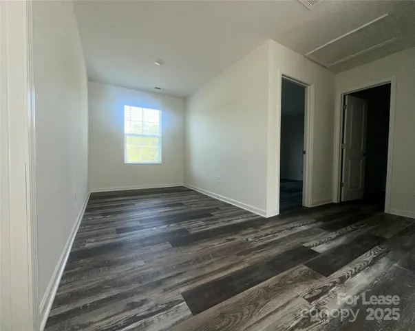 a view of wooden floor and windows in a room