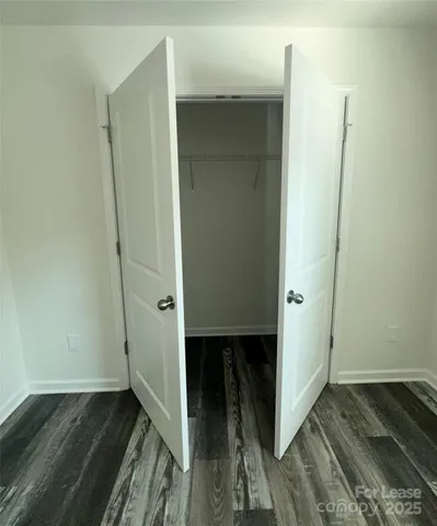 a view of a room with wooden floor and window
