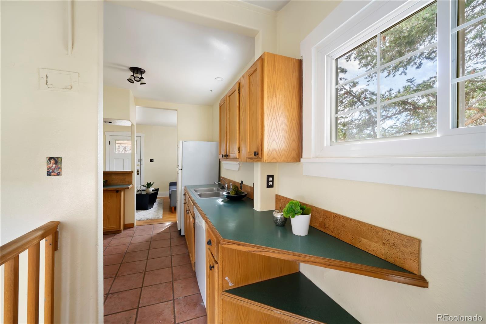 2901 Chase Street Wheat Ridge, CO 80214 - Photo 7 of 33 a kitchen with stainless steel appliances a sink a stove and a refrigerator