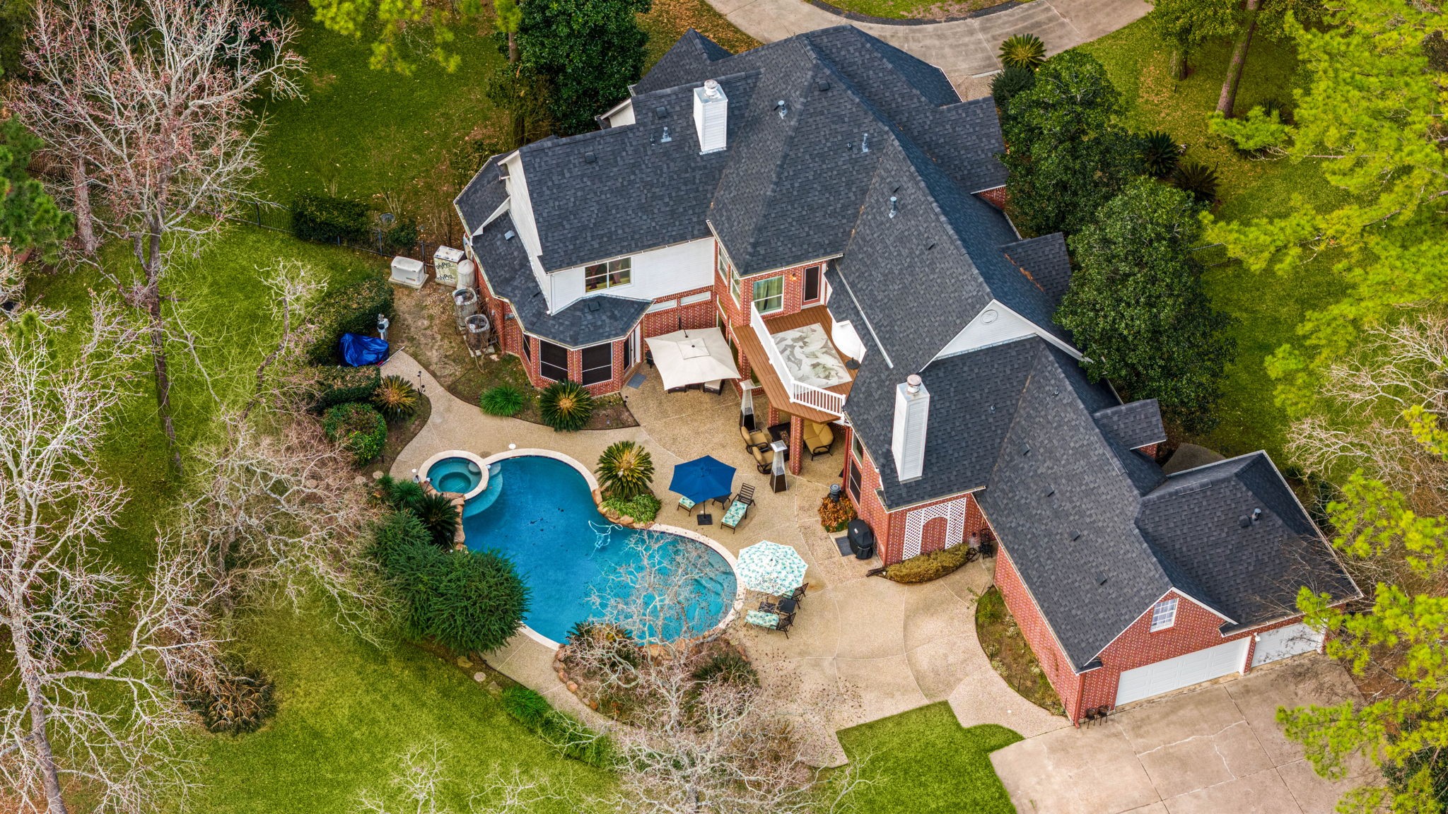 an aerial view of residential house with outdoor space and swimming pool