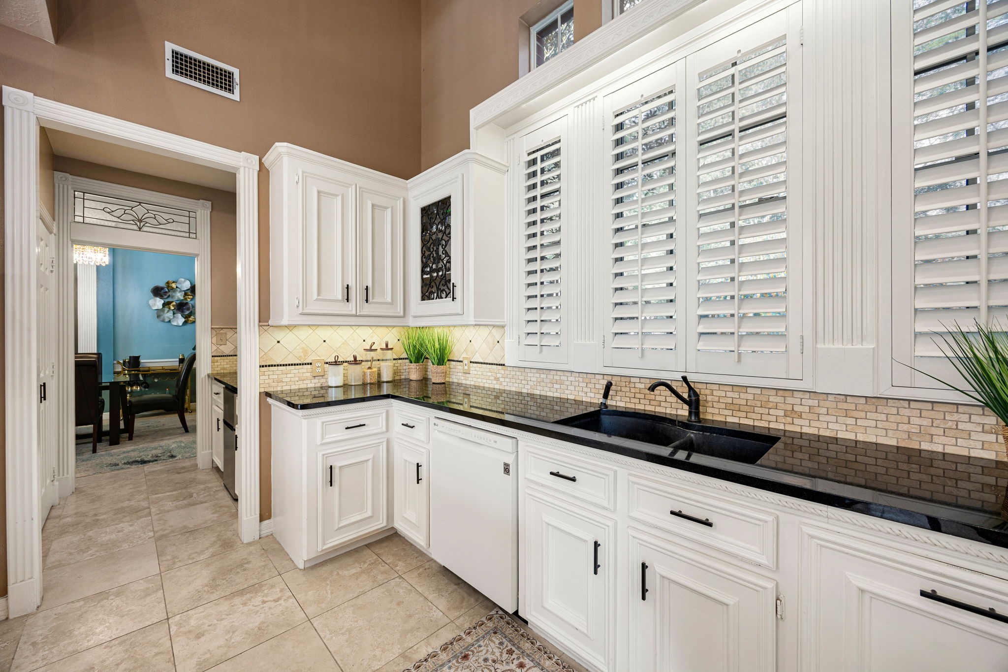 17511 Hawkin Lane Tomball, TX 77377 - Photo 14 of 49 a kitchen with granite countertop a sink and a white cabinets