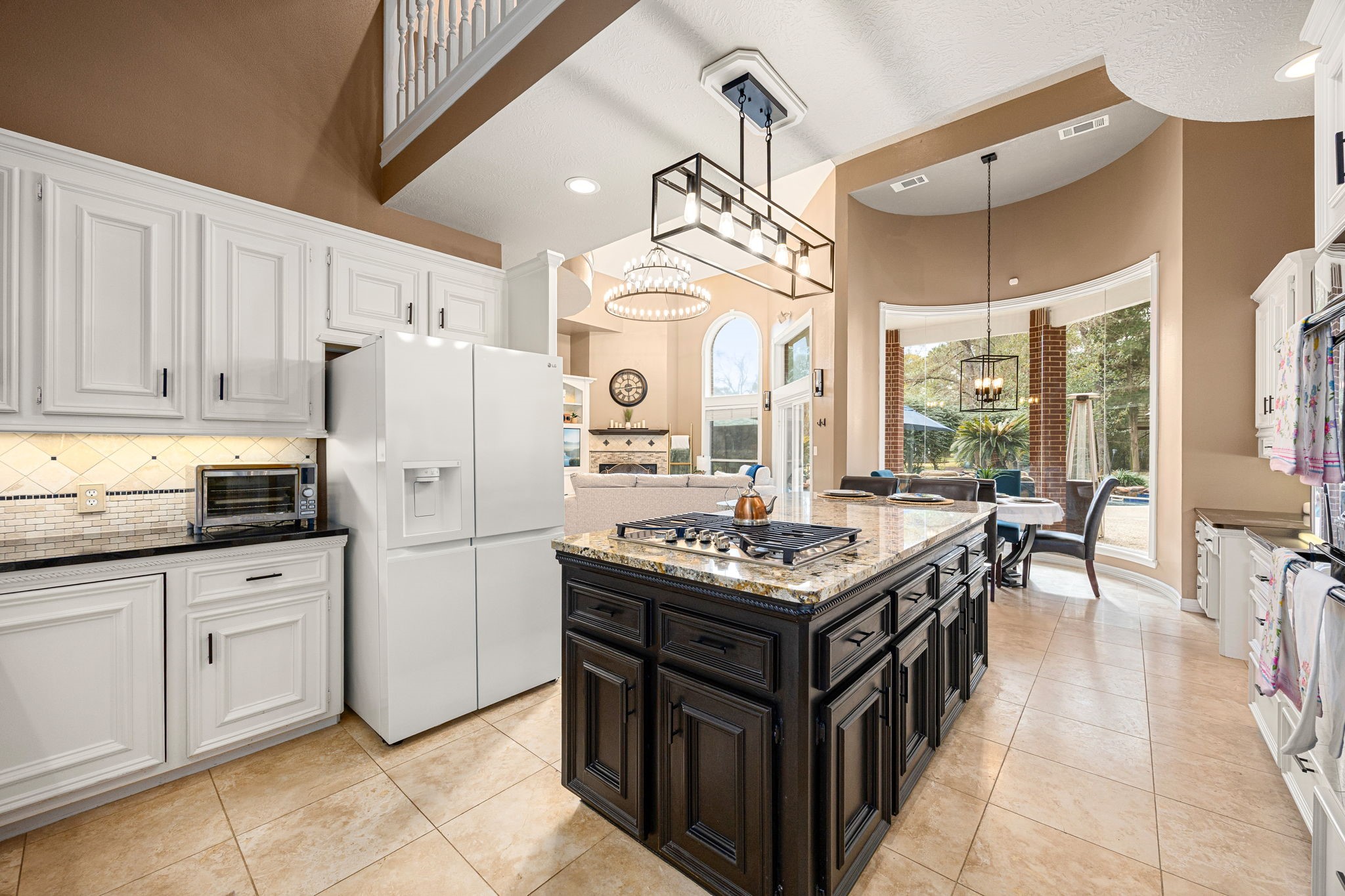 17511 Hawkin Lane Tomball, TX 77377 - Photo 15 of 50 a kitchen with a stove a refrigerator and a dining table