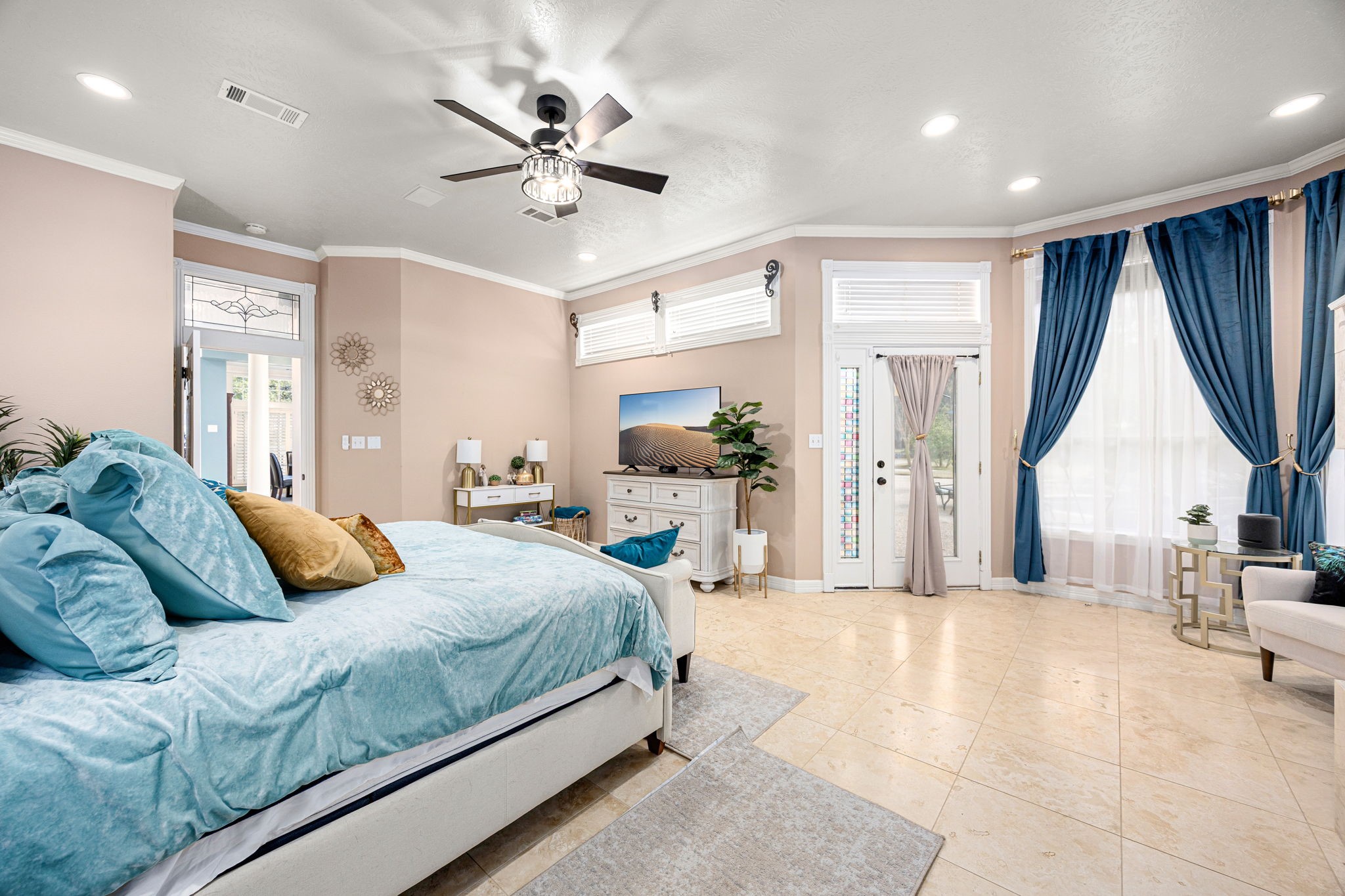 17511 Hawkin Lane Tomball, TX 77377 - Photo 22 of 50 a bedroom with a large bed a flat screen tv and a large window