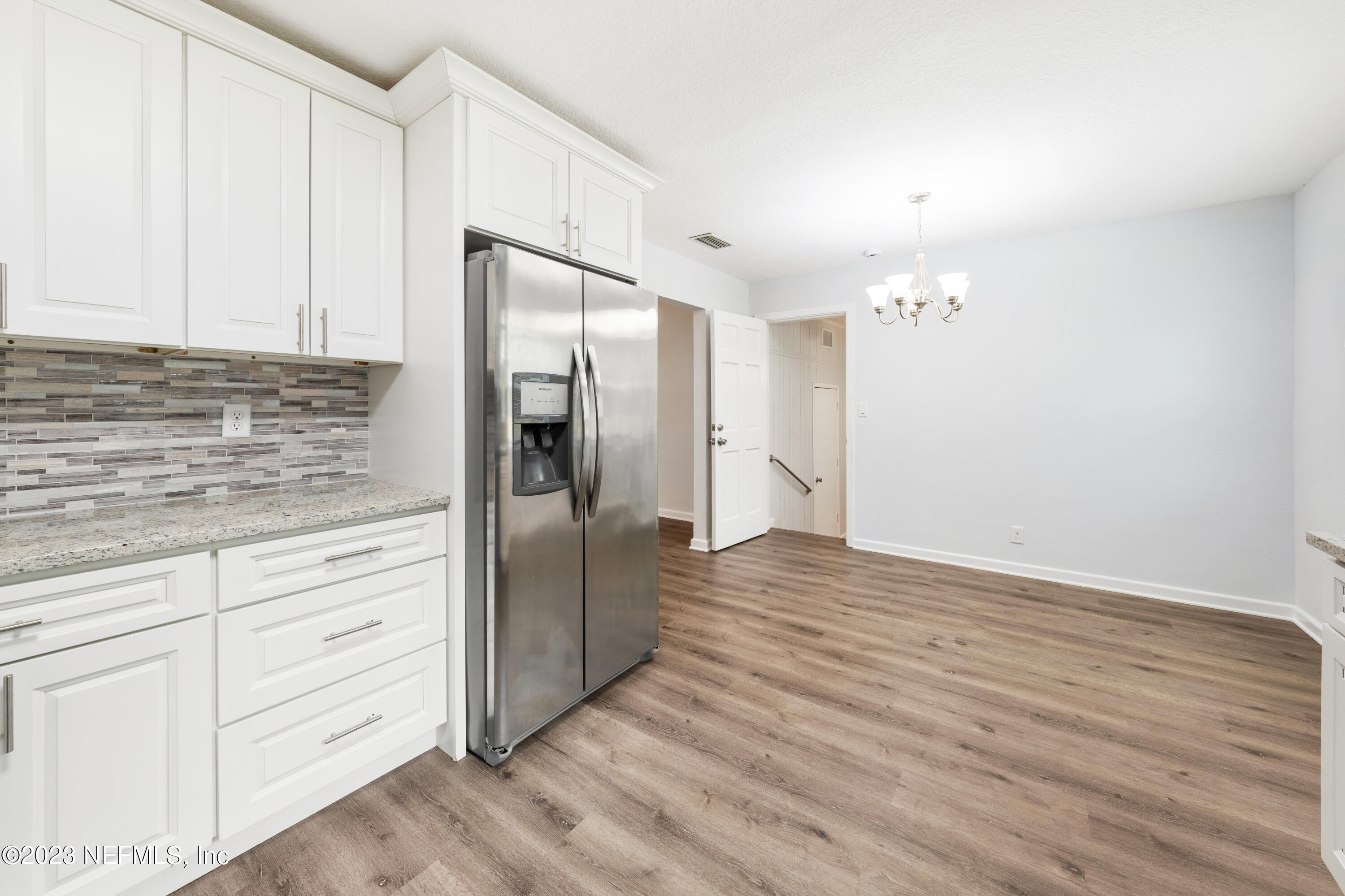 2704 Devonwood Road Jacksonville, FL 32211 - Photo 13 of 31 a kitchen with white cabinets and stainless steel appliances