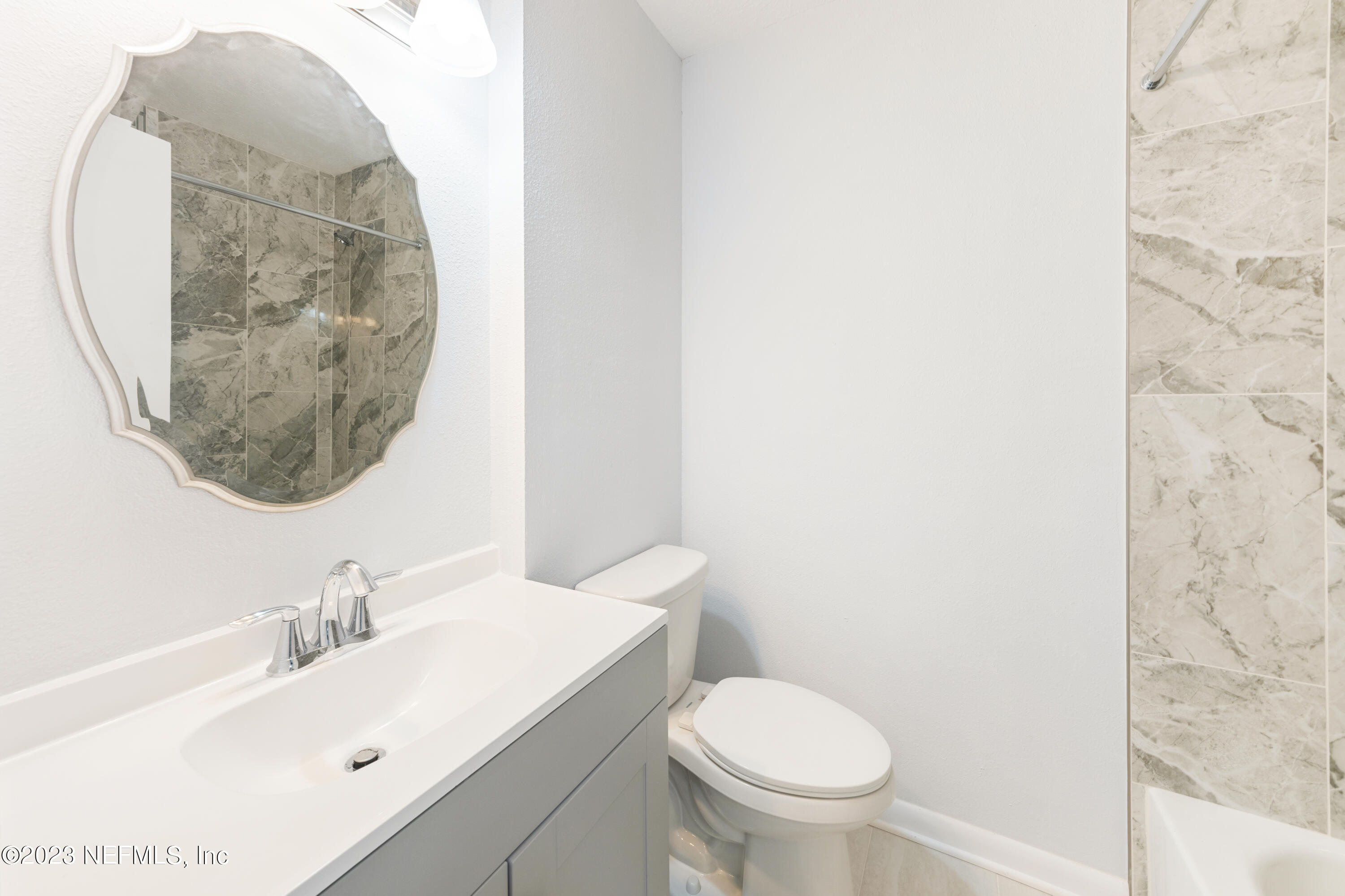 2704 Devonwood Road Jacksonville, FL 32211 - Photo 14 of 31 a bathroom with a sink and a mirror