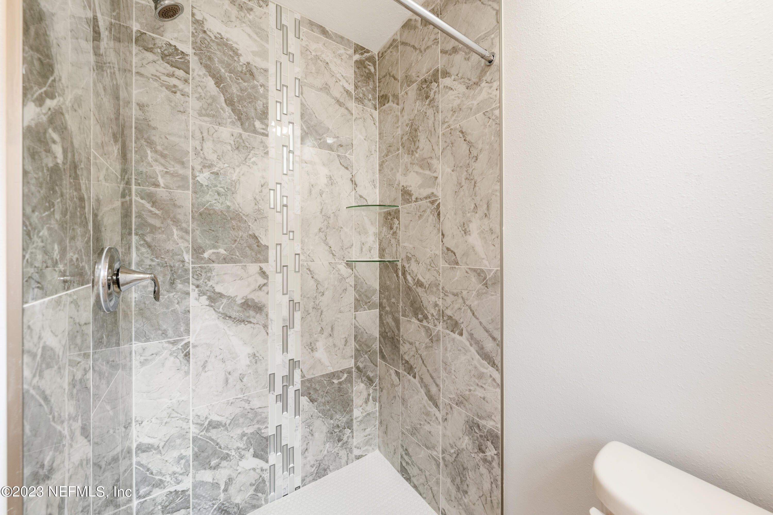 2704 Devonwood Road Jacksonville, FL 32211 - Photo 23 of 31 a bathroom with a shower curtain