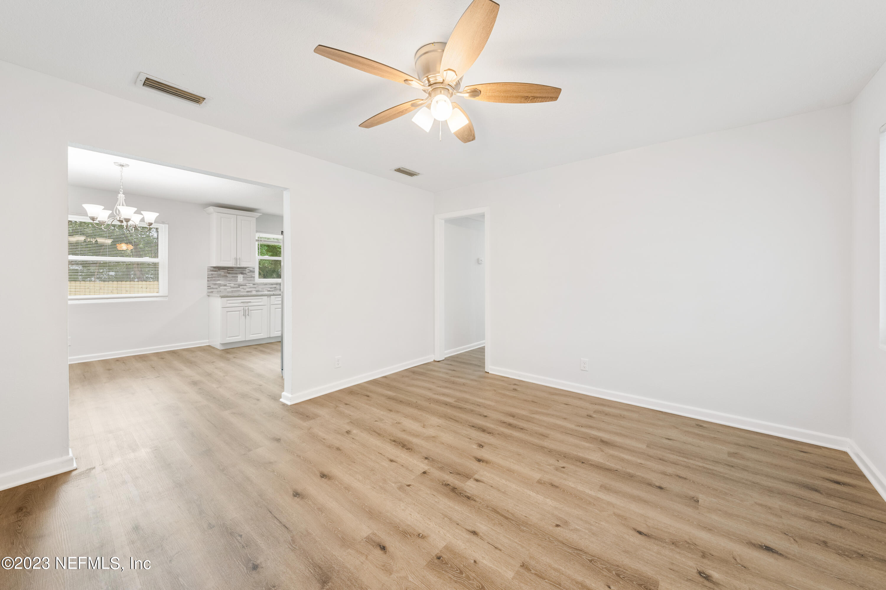 2704 Devonwood Road Jacksonville, FL 32211 - Photo 5 of 31 wooden floor in an empty room with a window