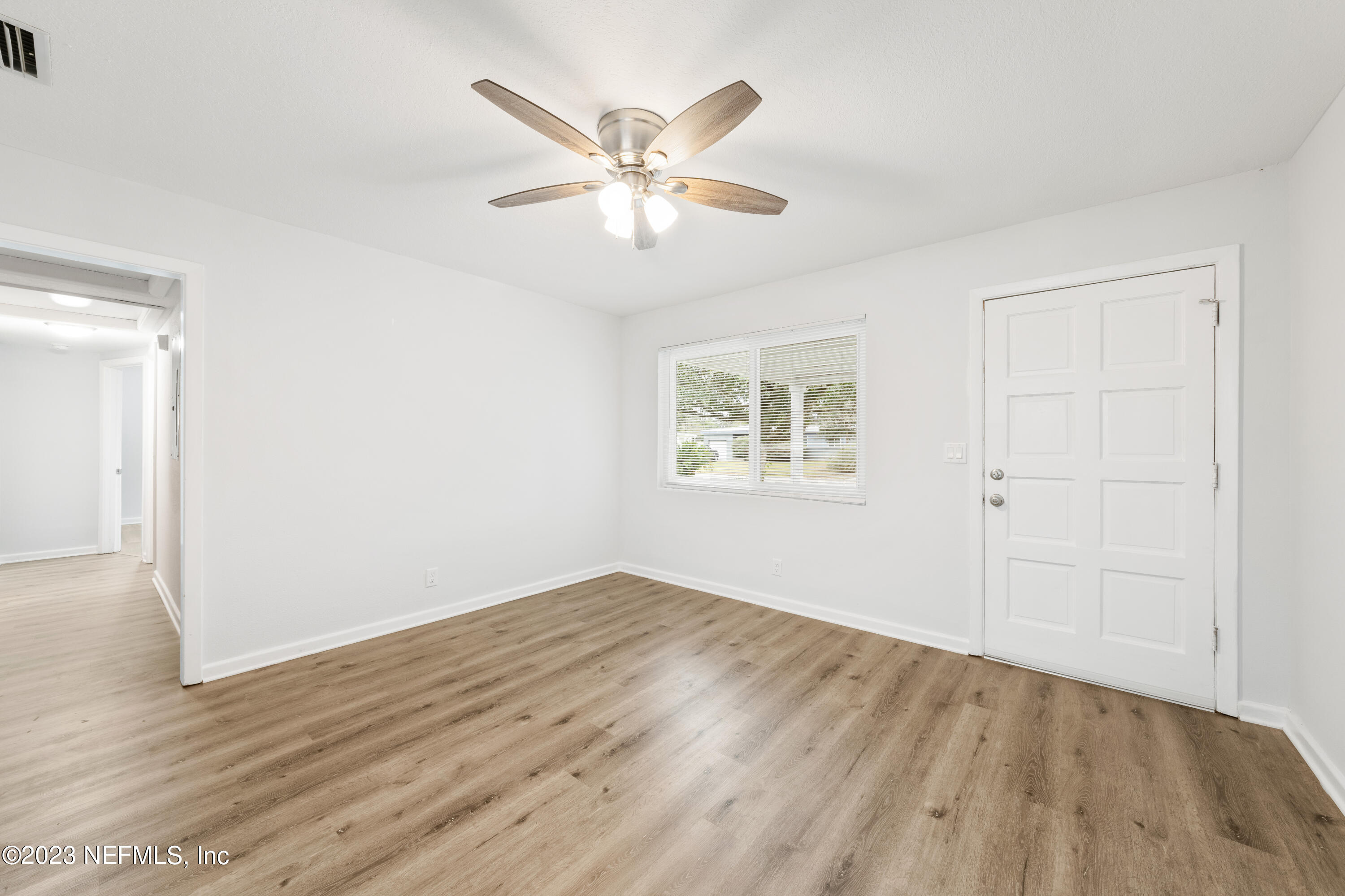 2704 Devonwood Road Jacksonville, FL 32211 - Photo 6 of 31 wooden floor in an empty room with a window