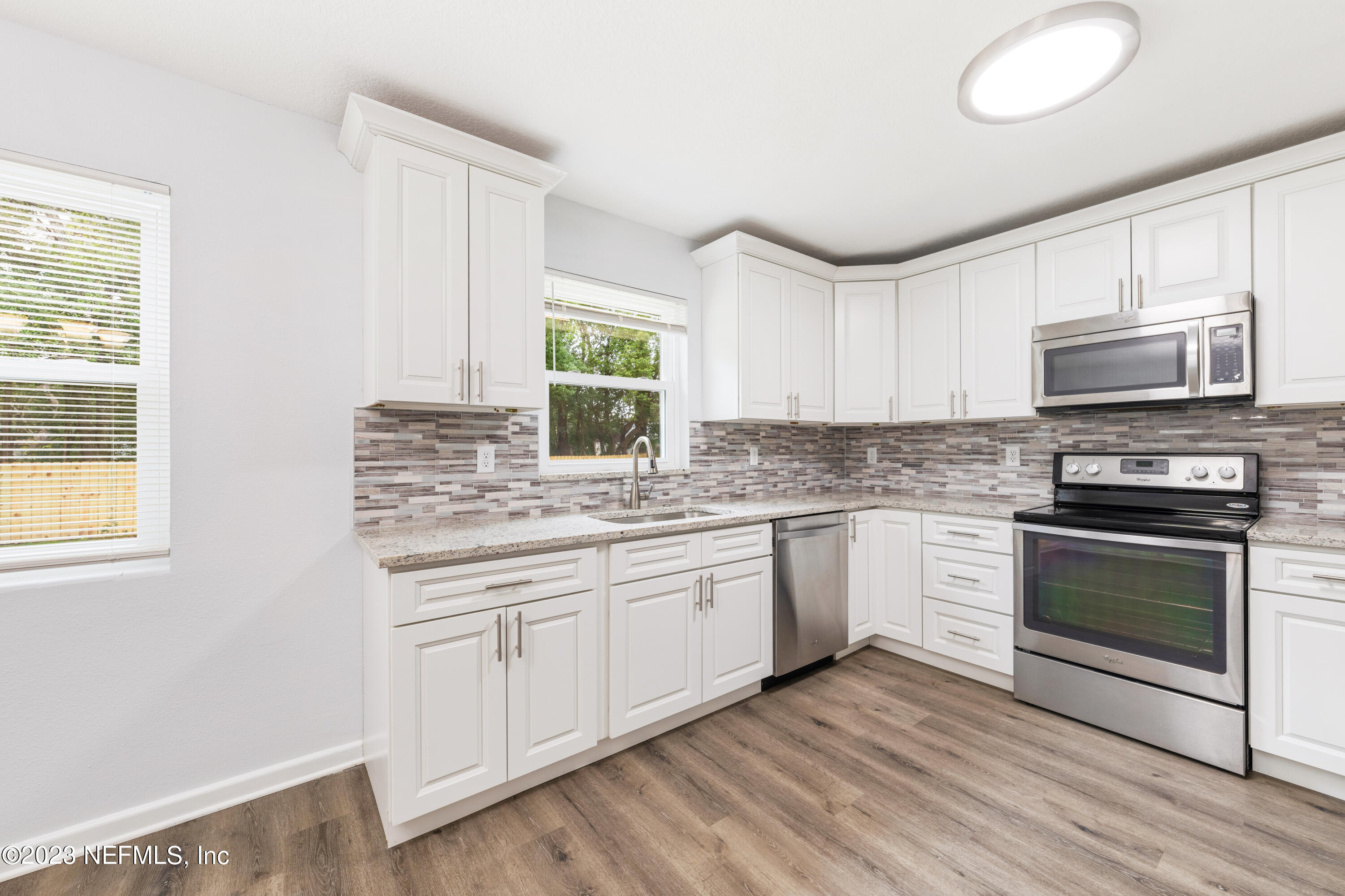 2704 Devonwood Road Jacksonville, FL 32211 - Photo 10 of 31 a kitchen with stainless steel appliances granite countertop a stove a sink and a microwave