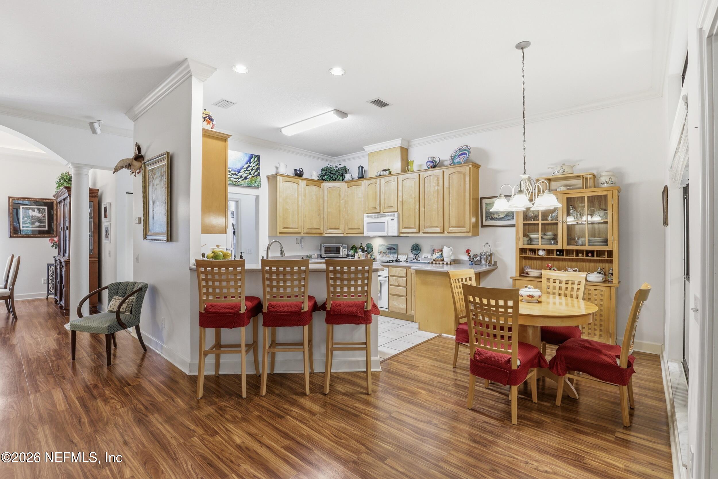 6455 Brooklyn Bay Road Keystone Heights, FL 32656 - Photo 12 of 50 a kitchen with stainless steel appliances kitchen island granite countertop a dining table chairs and granite counter tops