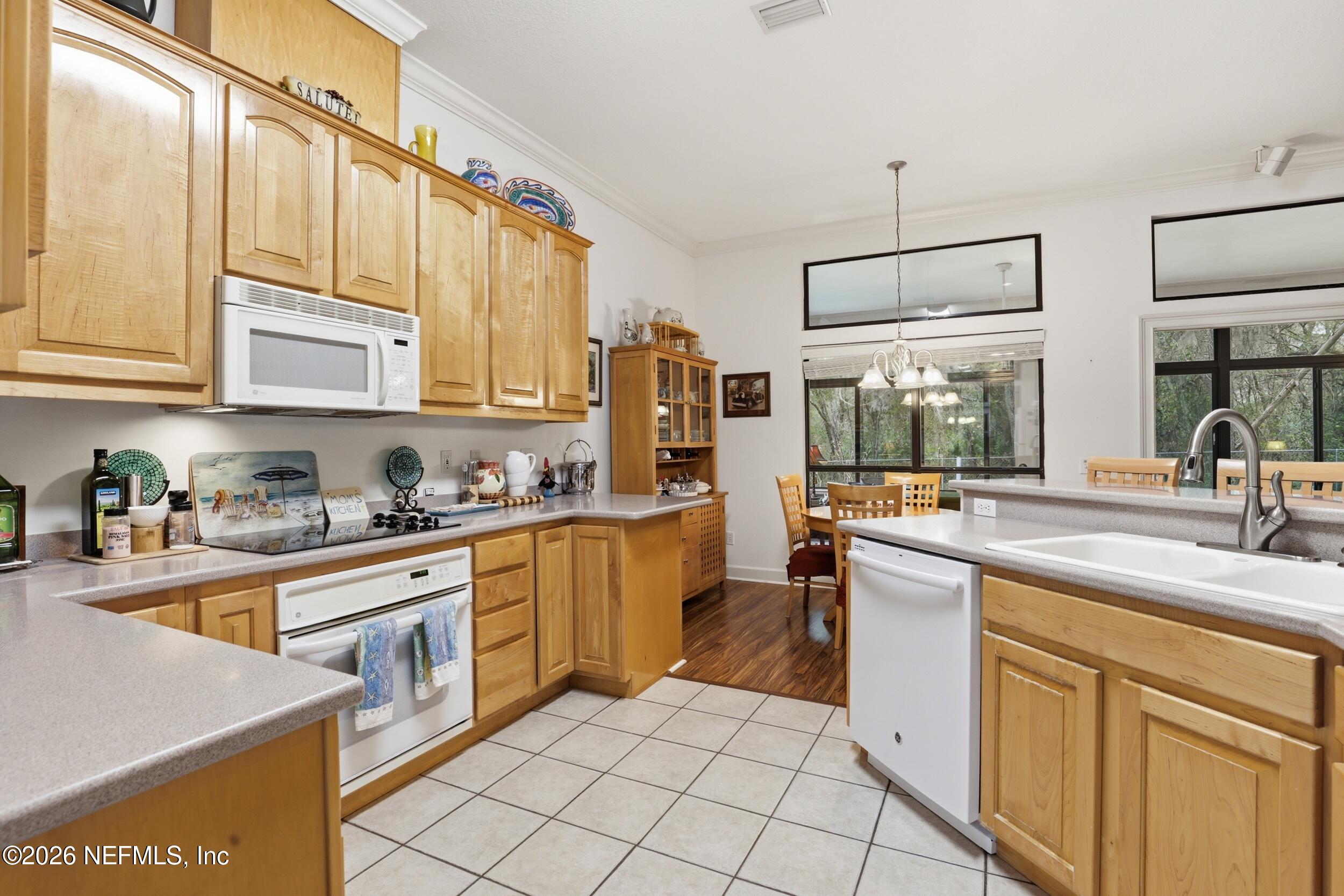 6455 Brooklyn Bay Road Keystone Heights, FL 32656 - Photo 13 of 50 a kitchen with stainless steel appliances granite countertop a sink and cabinets