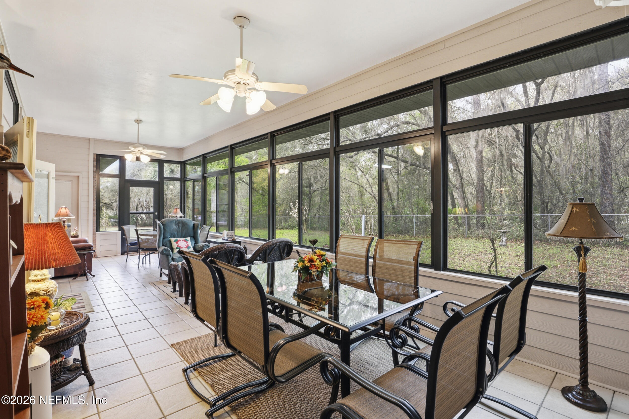 6455 Brooklyn Bay Road Keystone Heights, FL 32656 - Photo 17 of 50 a living room with furniture and floor to ceiling windows
