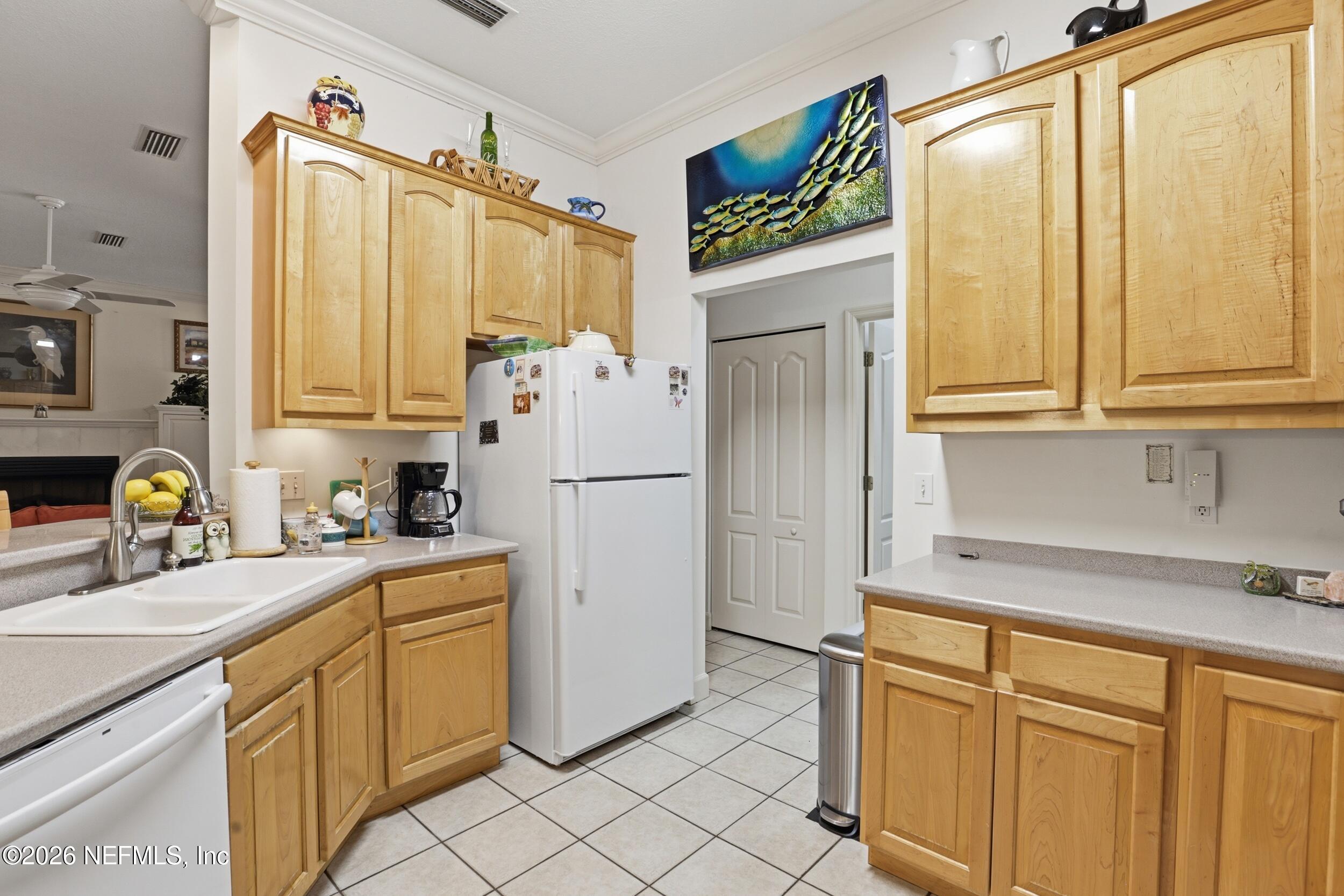 6455 Brooklyn Bay Road Keystone Heights, FL 32656 - Photo 18 of 50 a kitchen with stainless steel appliances a refrigerator sink and cabinets