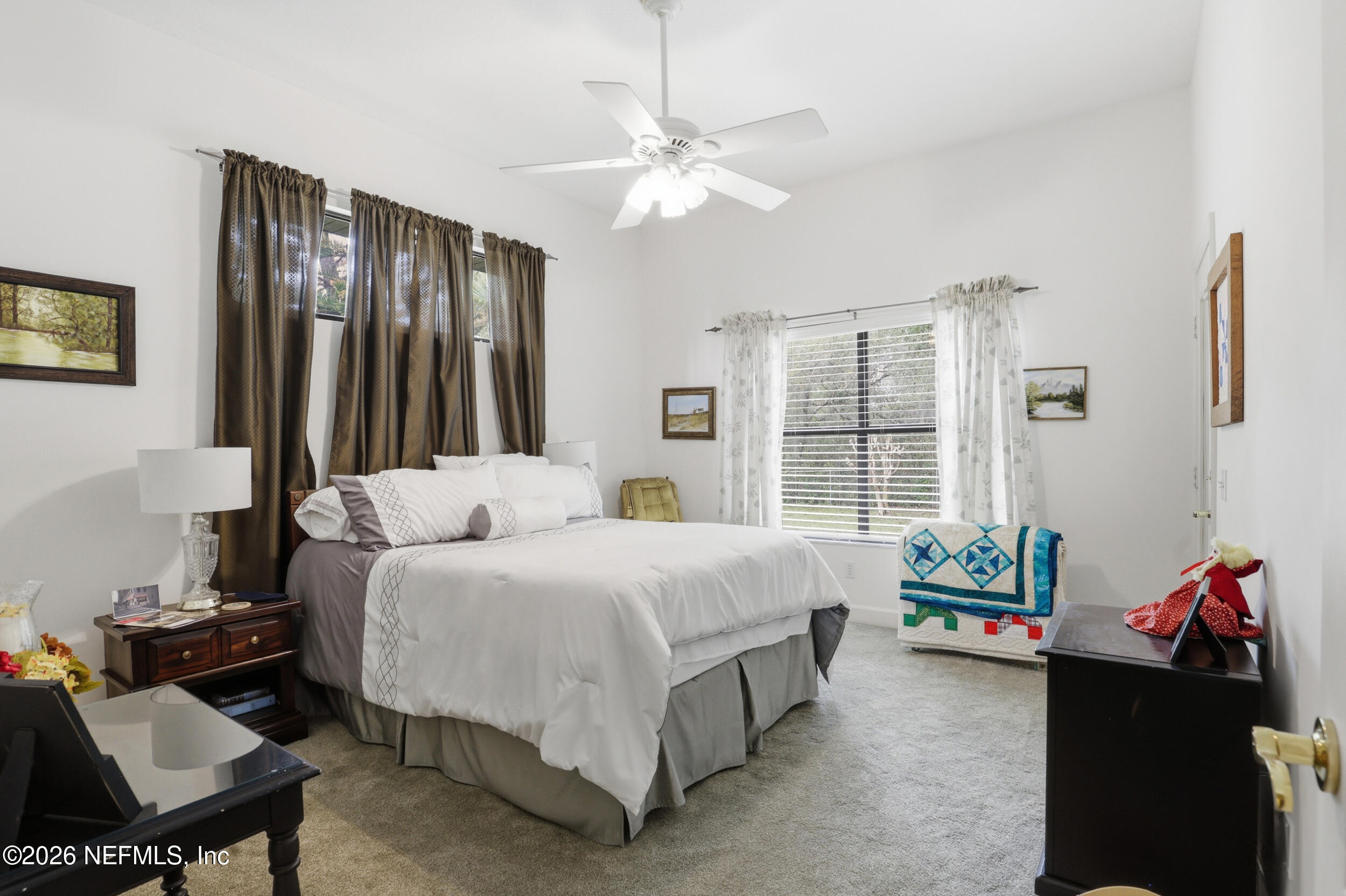 6455 Brooklyn Bay Road Keystone Heights, FL 32656 - Photo 24 of 50 a bedroom with a bed and a chandelier