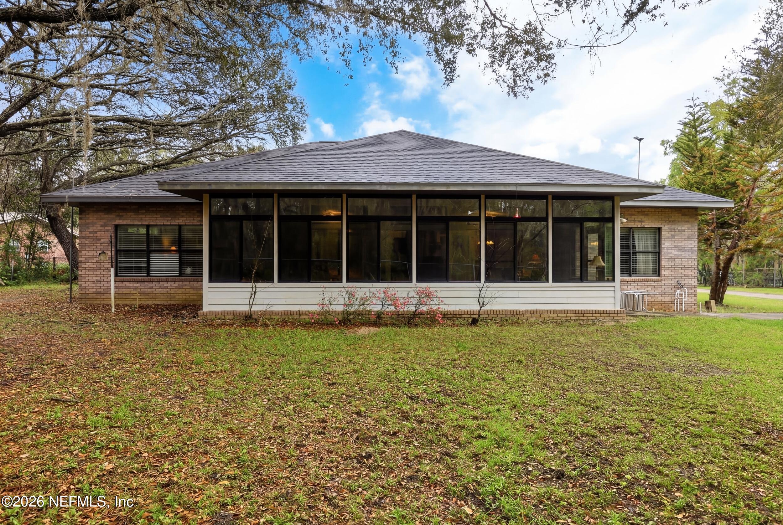 6455 Brooklyn Bay Road Keystone Heights, FL 32656 - Photo 30 of 50 a view of a house with a backyard
