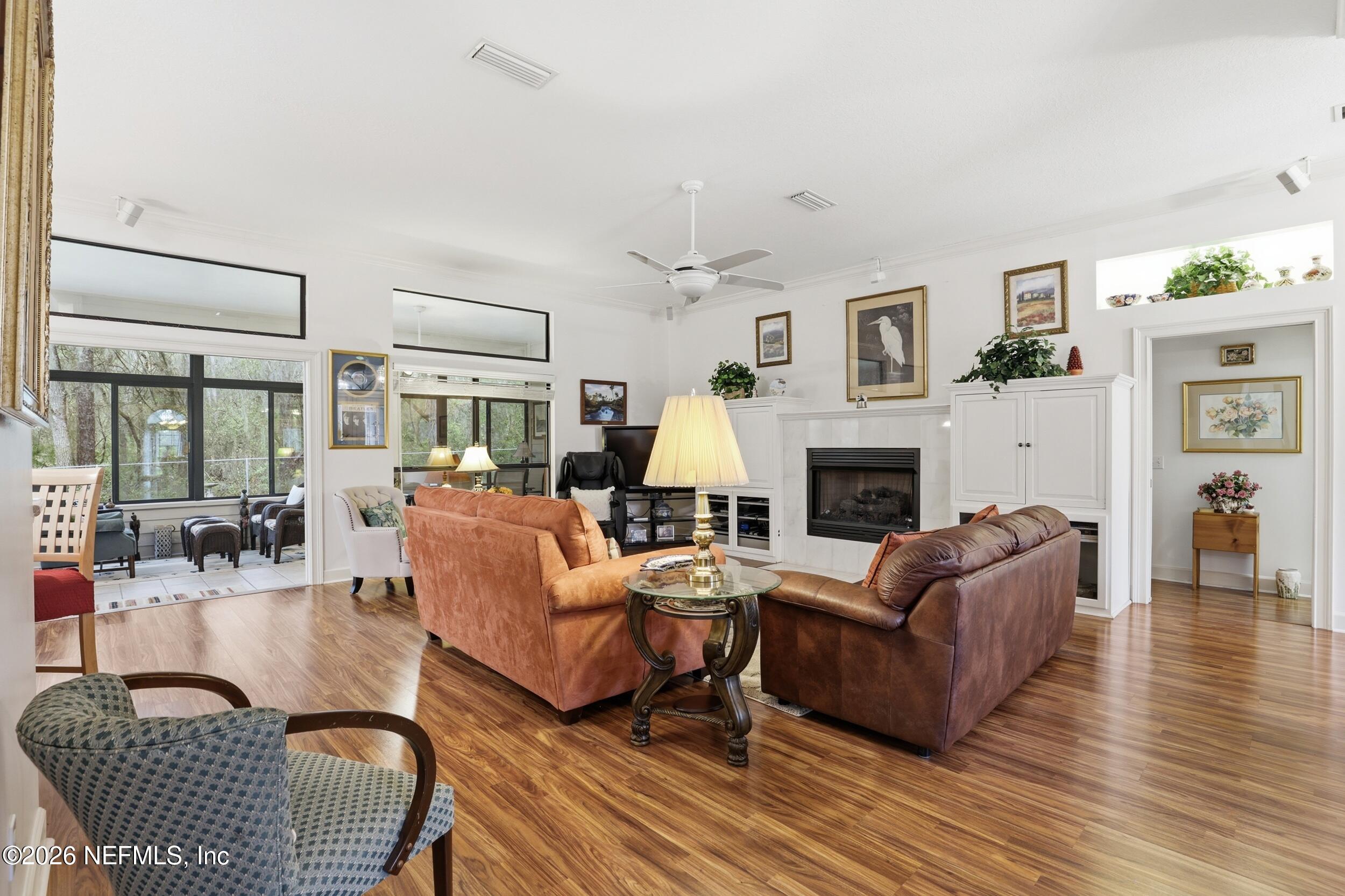 6455 Brooklyn Bay Road Keystone Heights, FL 32656 - Photo 7 of 50 a living room with fireplace furniture and a wooden floor