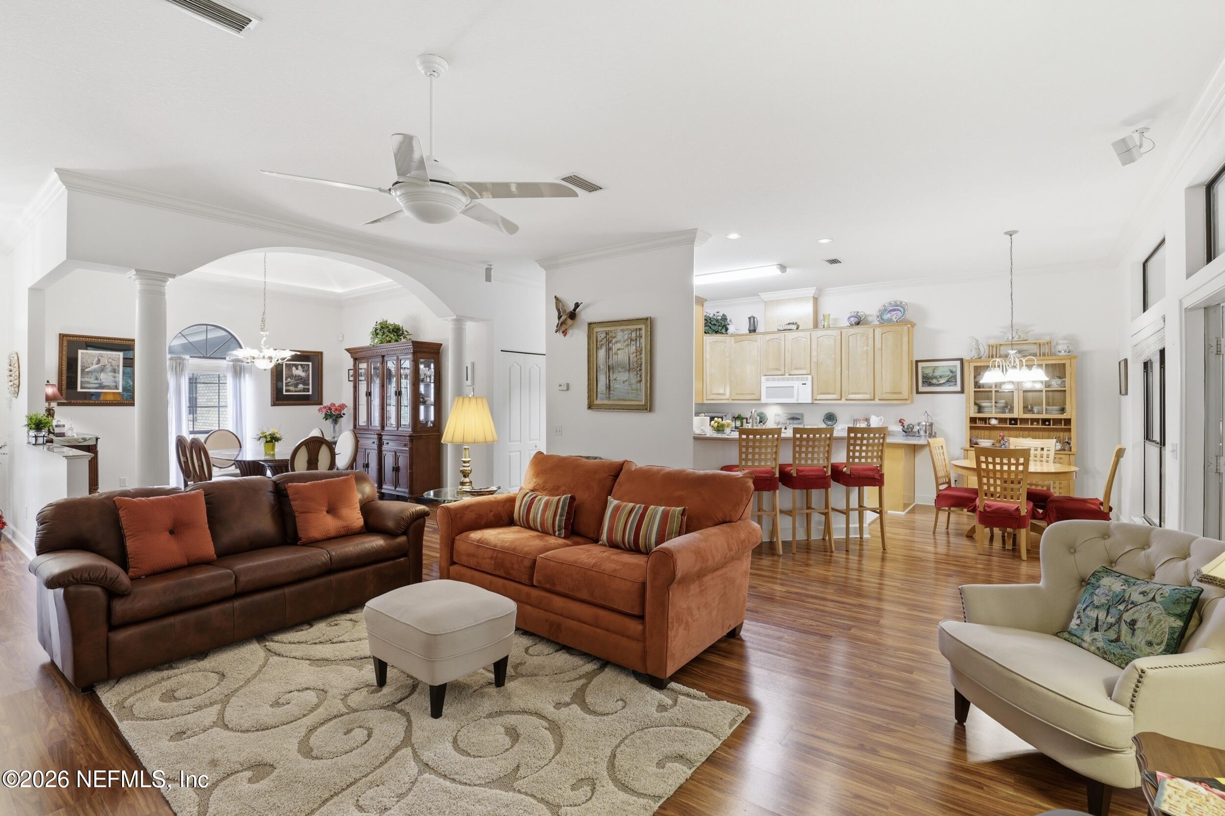 6455 Brooklyn Bay Road Keystone Heights, FL 32656 - Photo 10 of 50 a living room with furniture kitchen view and a chandelier