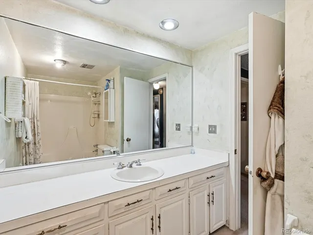 a bathroom with a granite countertop sink mirror and double