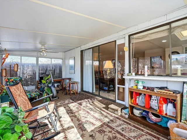 a living room with lots of furniture and a potted plant