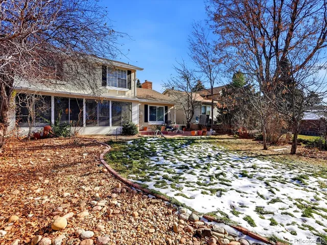 a view of a town with large trees and plants