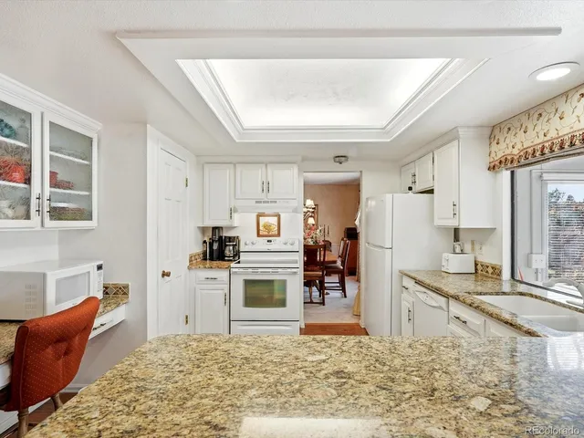 a living room with stainless steel appliances kitchen island granite countertop furniture and a kitchen view