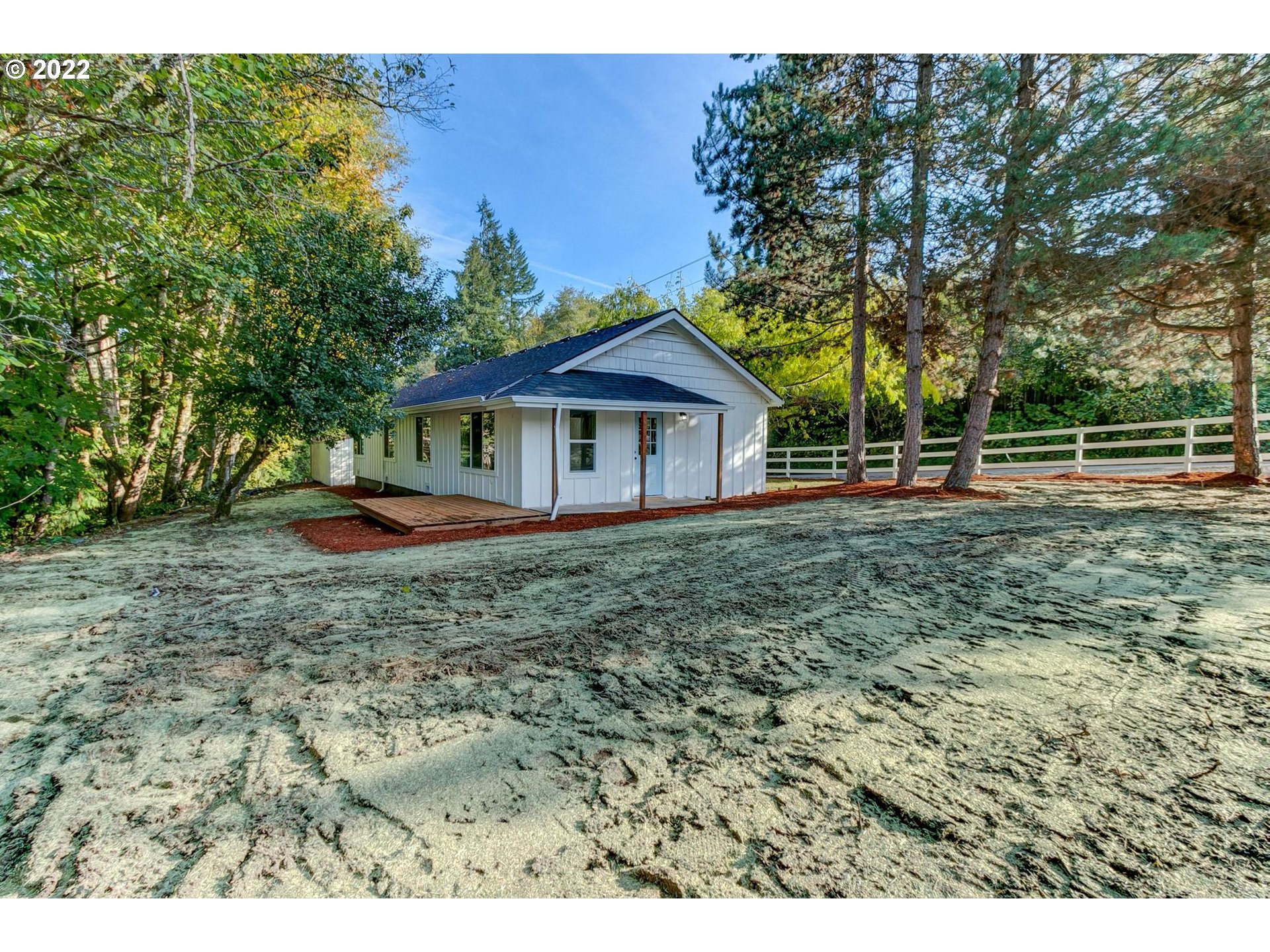33719 Bennett Road Warren, OR 97053 - Photo 30 of 32 a backyard of a house with plants and wooden fence