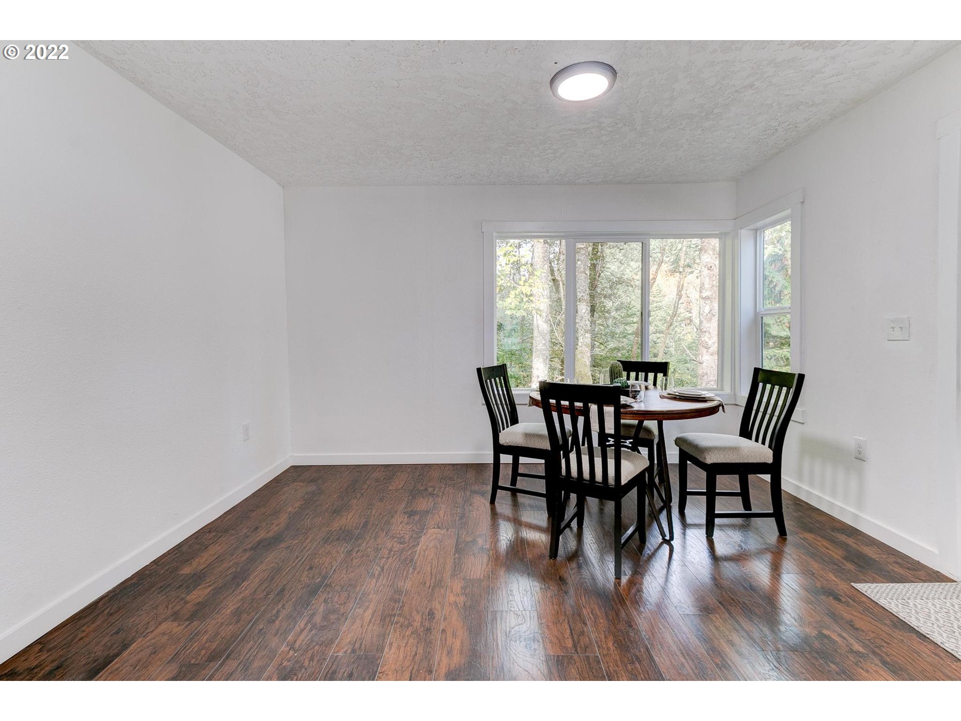 33719 Bennett Road Warren, OR 97053 - Photo 10 of 32 a view of a dining room with furniture and wooden floor