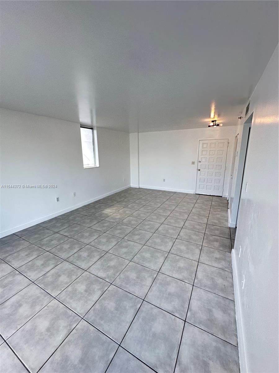 Nirvana Condominiums Miami, FL 33138 - Photo 2 of 13 an empty room with white walls and tiles