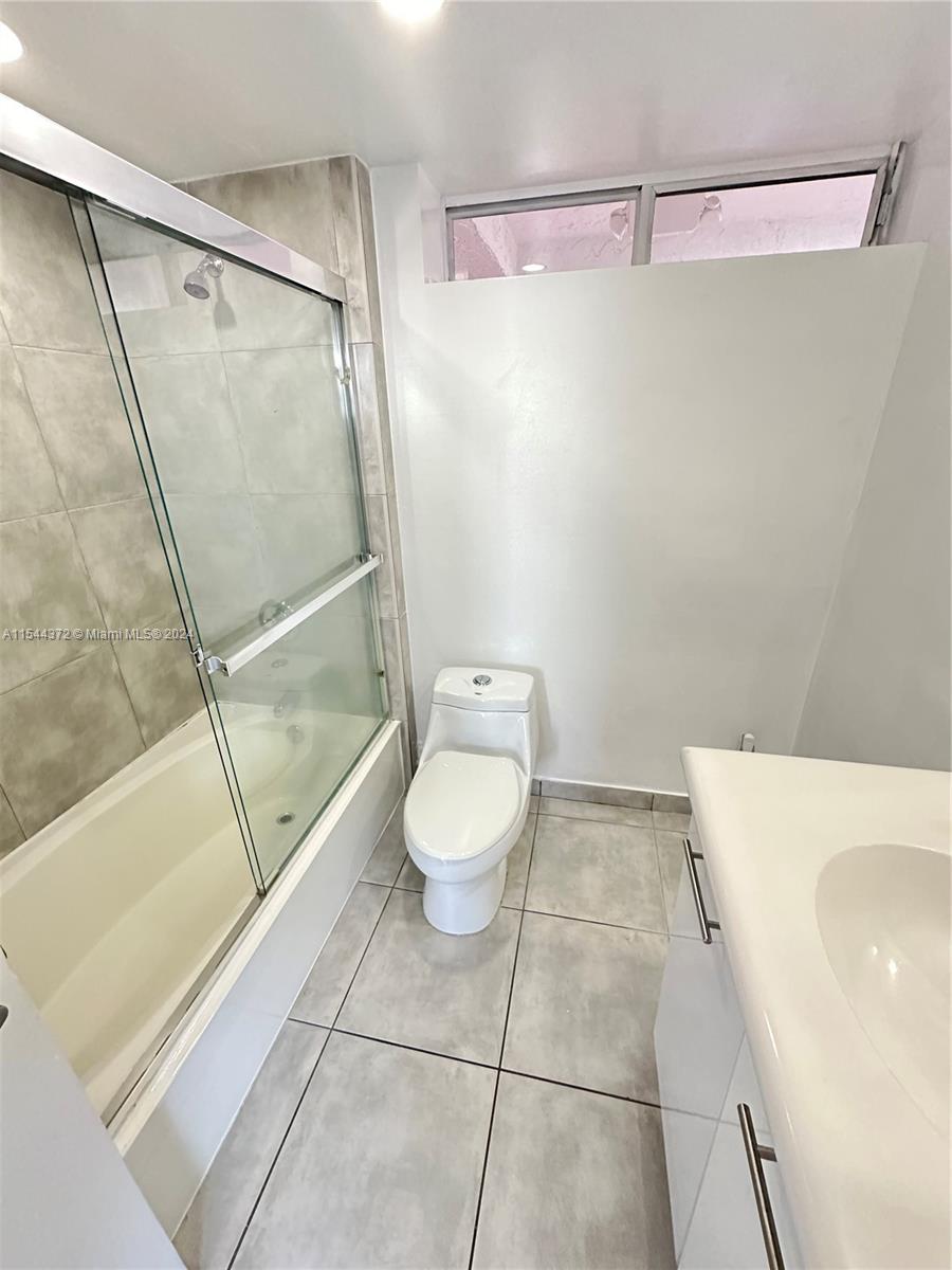 Nirvana Condominiums Miami, FL 33138 - Photo 3 of 13 a bathroom with a granite countertop shower and a toilet