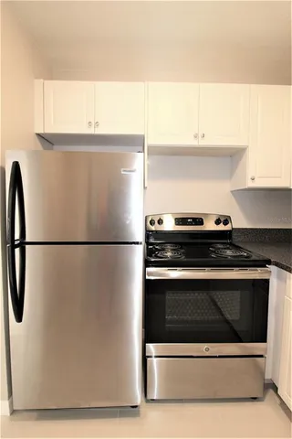 a close view of a stove top oven and refrigerator