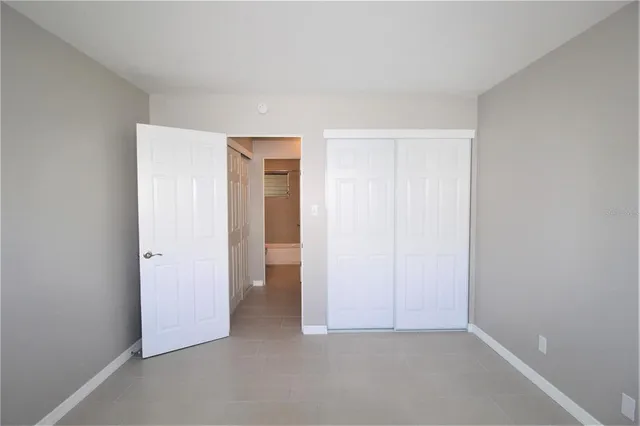 an empty room with closet area