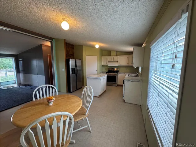a kitchen with refrigerator cabinets and furniture