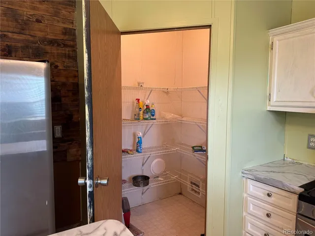 a bathroom with a granite countertop toilet and a shower