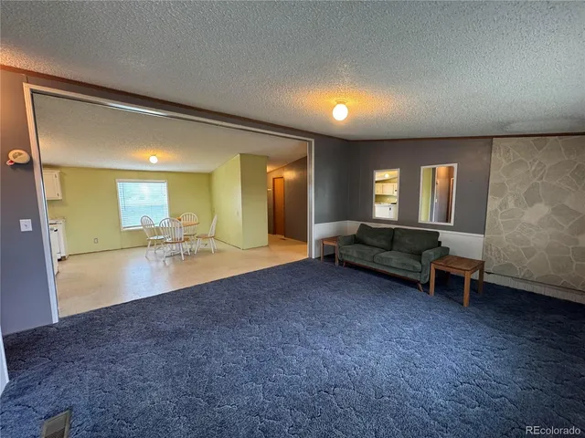a lobby with furniture and a wooden floor