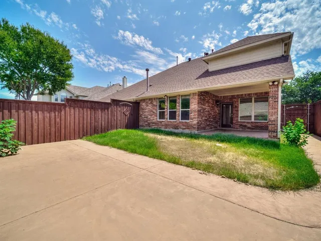 a view of a house with a yard and plants