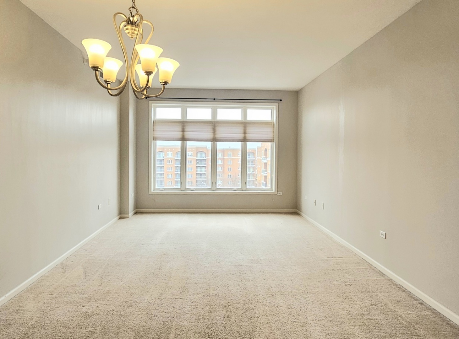 390 Western Avenue, Unit 702 Des Plaines, IL 60016 - Photo 3 of 19 en view of an empty room with a chandelier fan