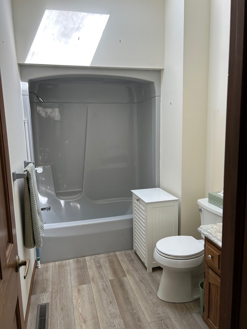 122 San Carlos Road Minooka, IL 60447 - Photo 11 of 35 a white toilet sitting next to a bathroom sink and tub