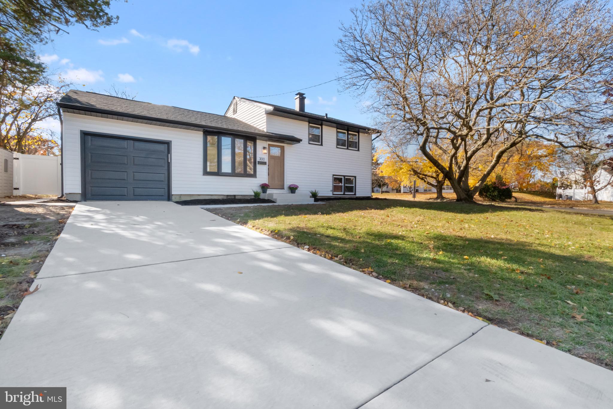 a view of a house with pool and trees in the background