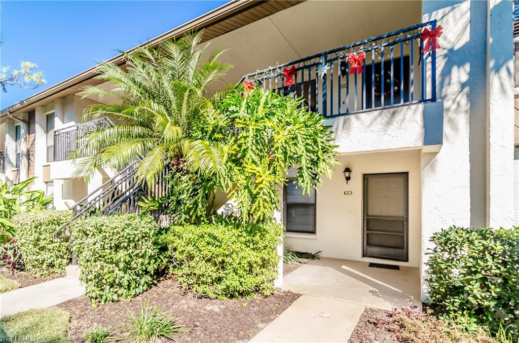 1220 Commonwealth Circle, Unit M106 Naples, FL 34116 - Photo 7 of 16 a front view of a house with plants