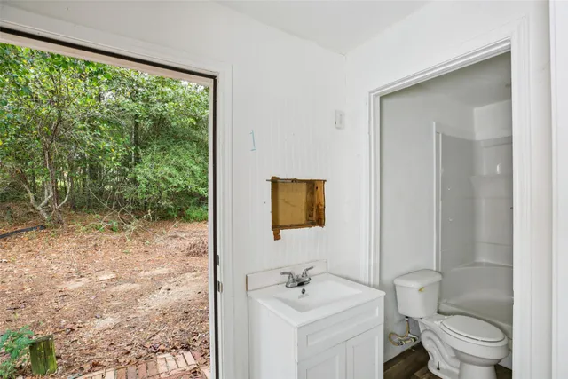 a bathroom with a toilet a sink and a mirror
