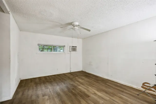 an empty room with a empty space and a ceiling fan