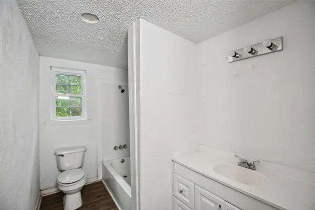 a bathroom with a toilet sink and shower