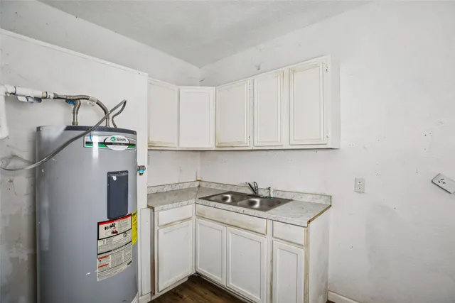 a utility room with cabinets washer and dryer