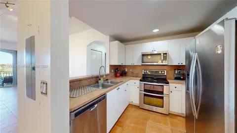 a bedroom with a bed and a view of kitchen